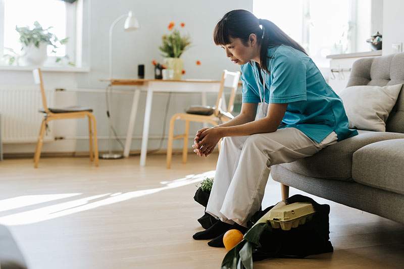 woman on couch looking down