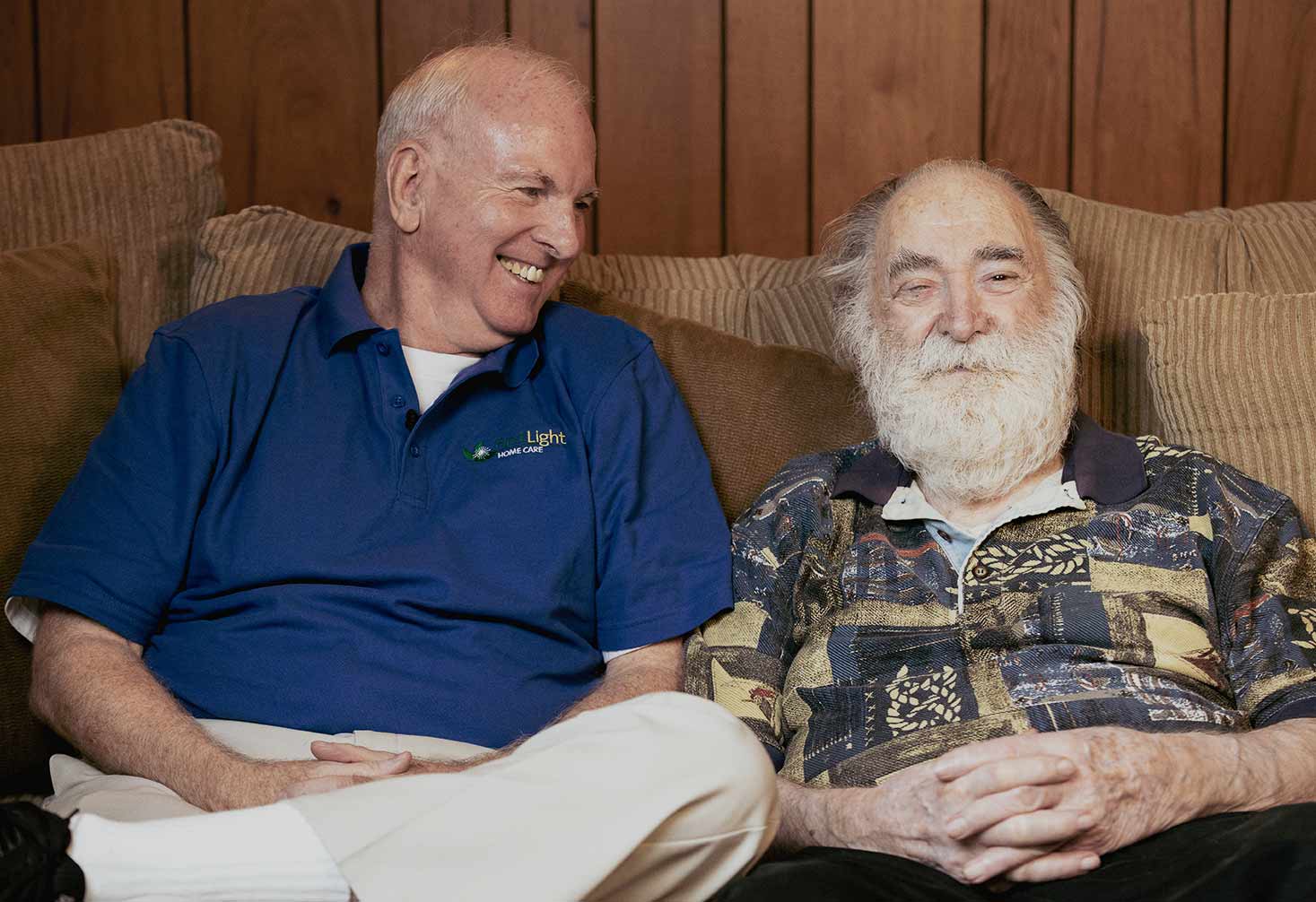 FirstLight Home Care Caregiver shares a laugh with one of our senior clients.